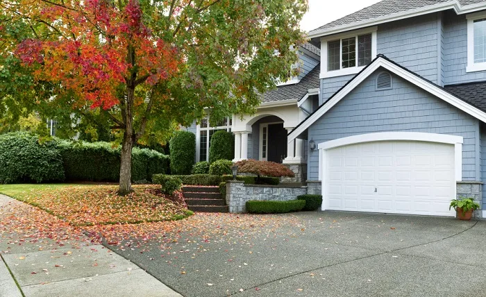 What Should Come First When Installing a Driveway? driveway front walkway view partial front residential home during early autumn season